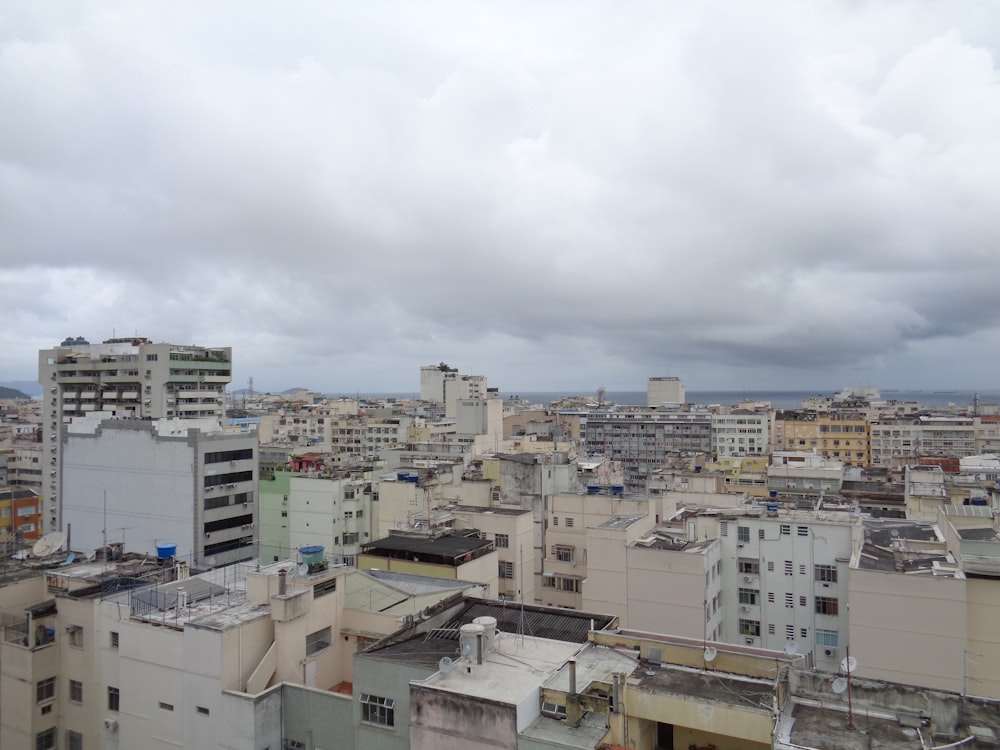 white and brown concrete buildings under white clouds during daytime