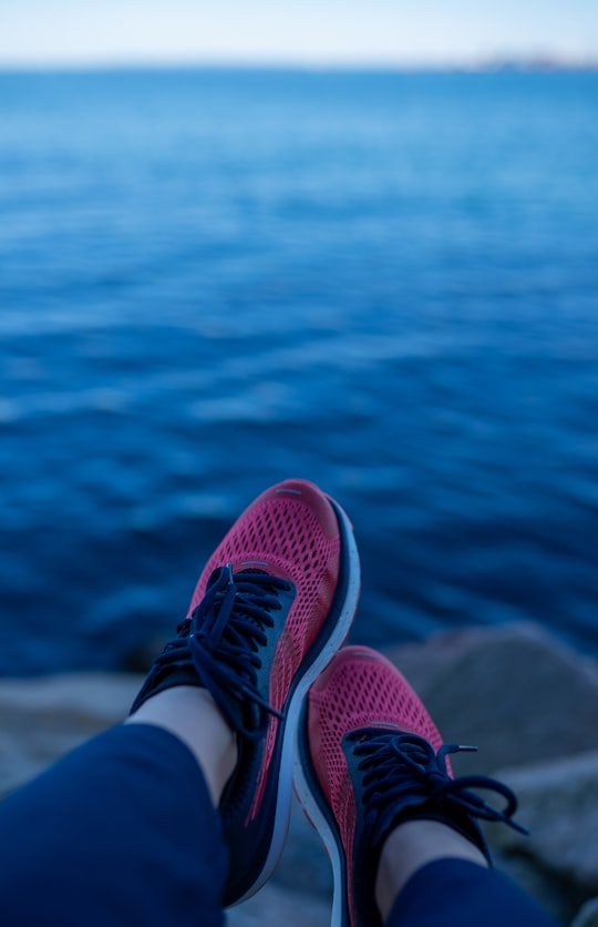 person wearing red and white sneakers in Aarhus Denmark