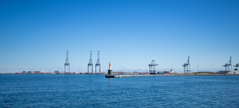 white and brown ship on sea under blue sky during daytime