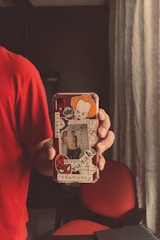 Customer happily holding their custom phone case at home.