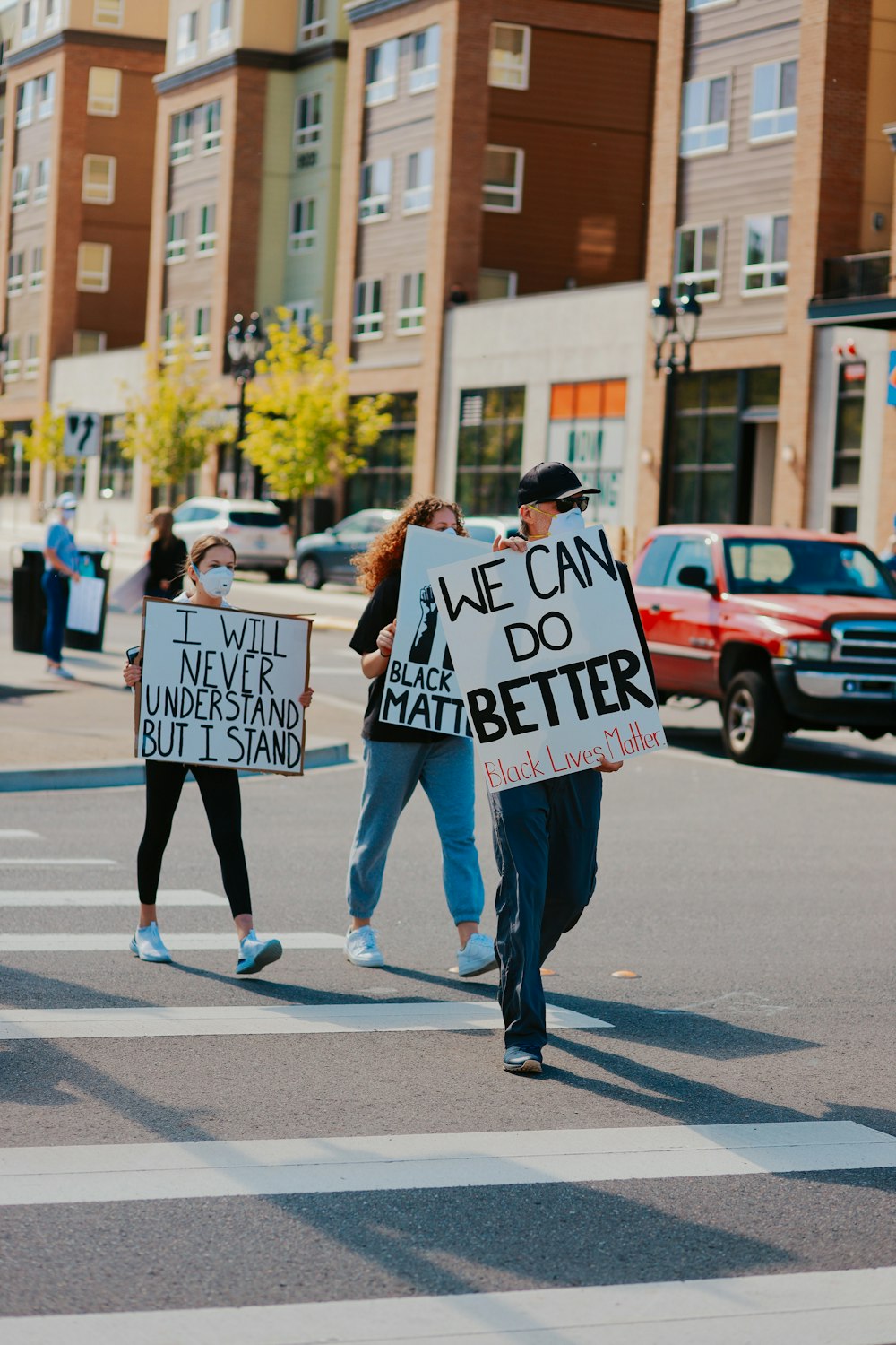 man in black and white long sleeve shirt holding white and black signage