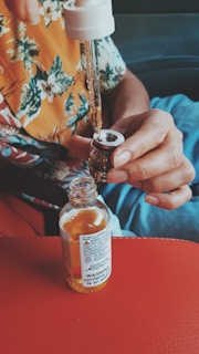 person holding white labeled glass bottle