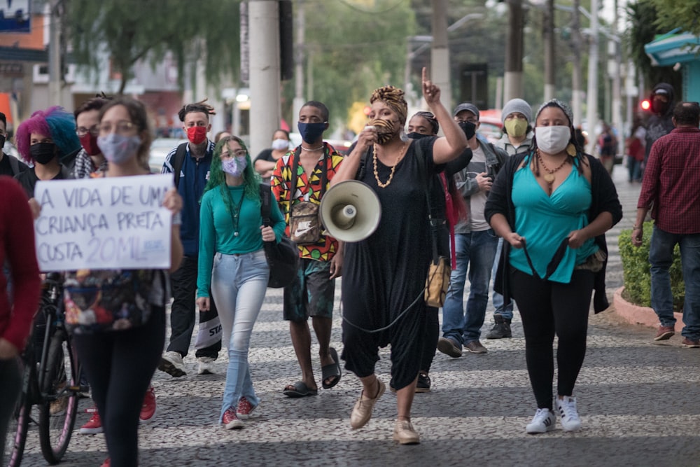 people standing on gray concrete pavement during daytime