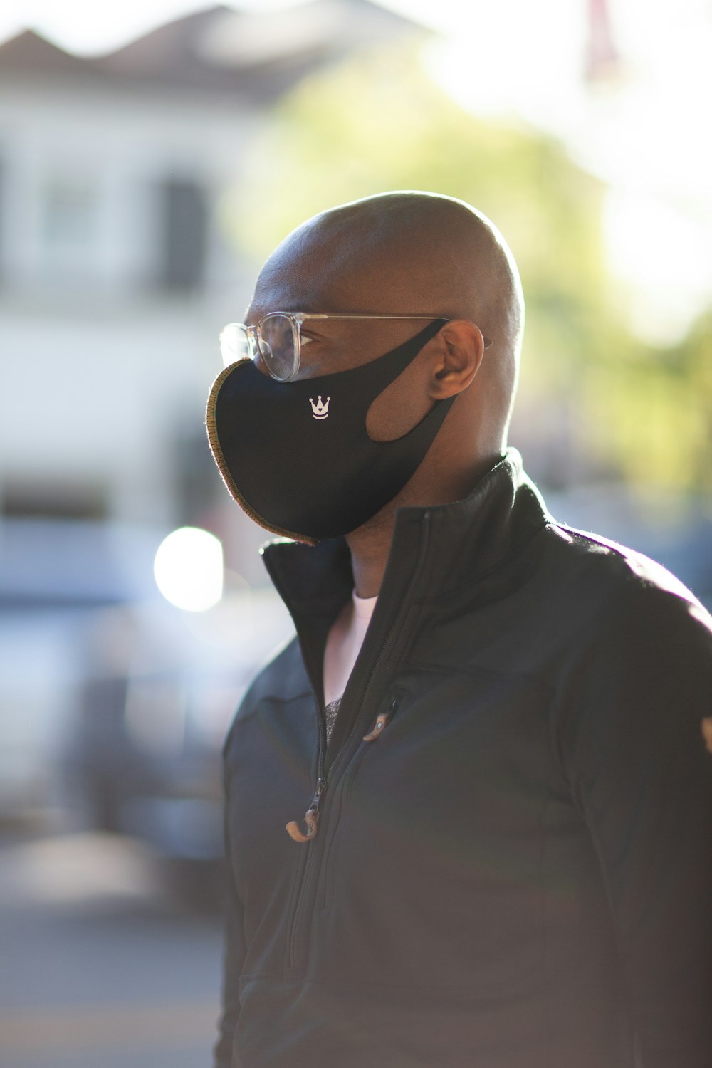 man in black zip up jacket wearing black sunglasses