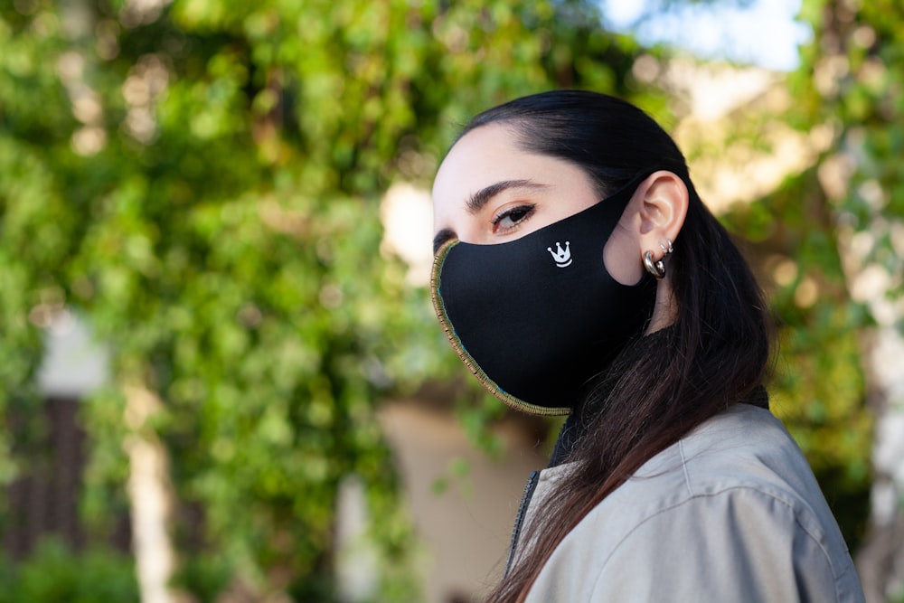 woman in white shirt wearing black mask