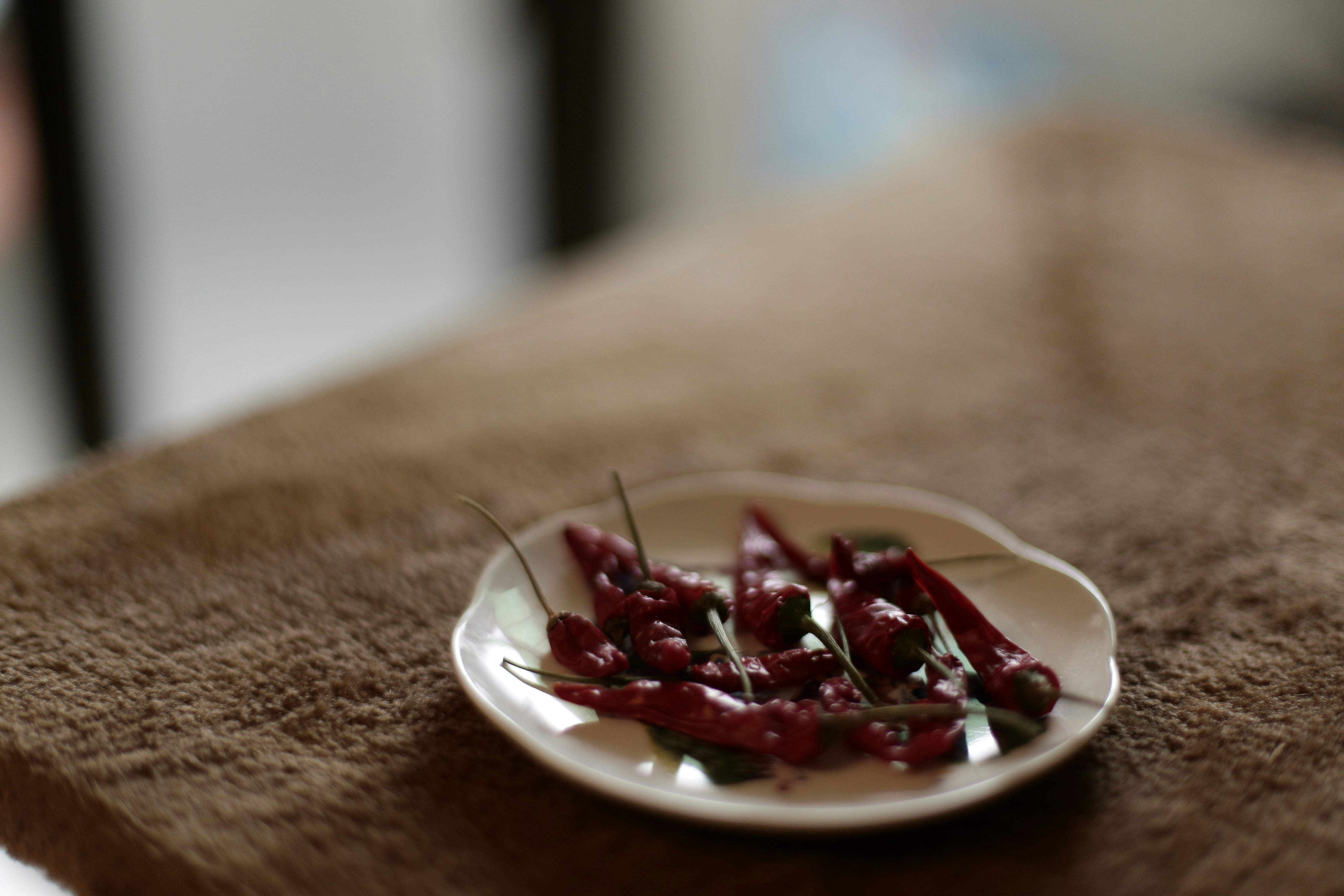 A jar of homemade chili crisp with crispy fried garlic and red chili flakes in glossy oil