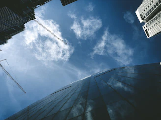 A detailed shot of construction cranes and modern buildings under development, reflecting growth and infrastructure.