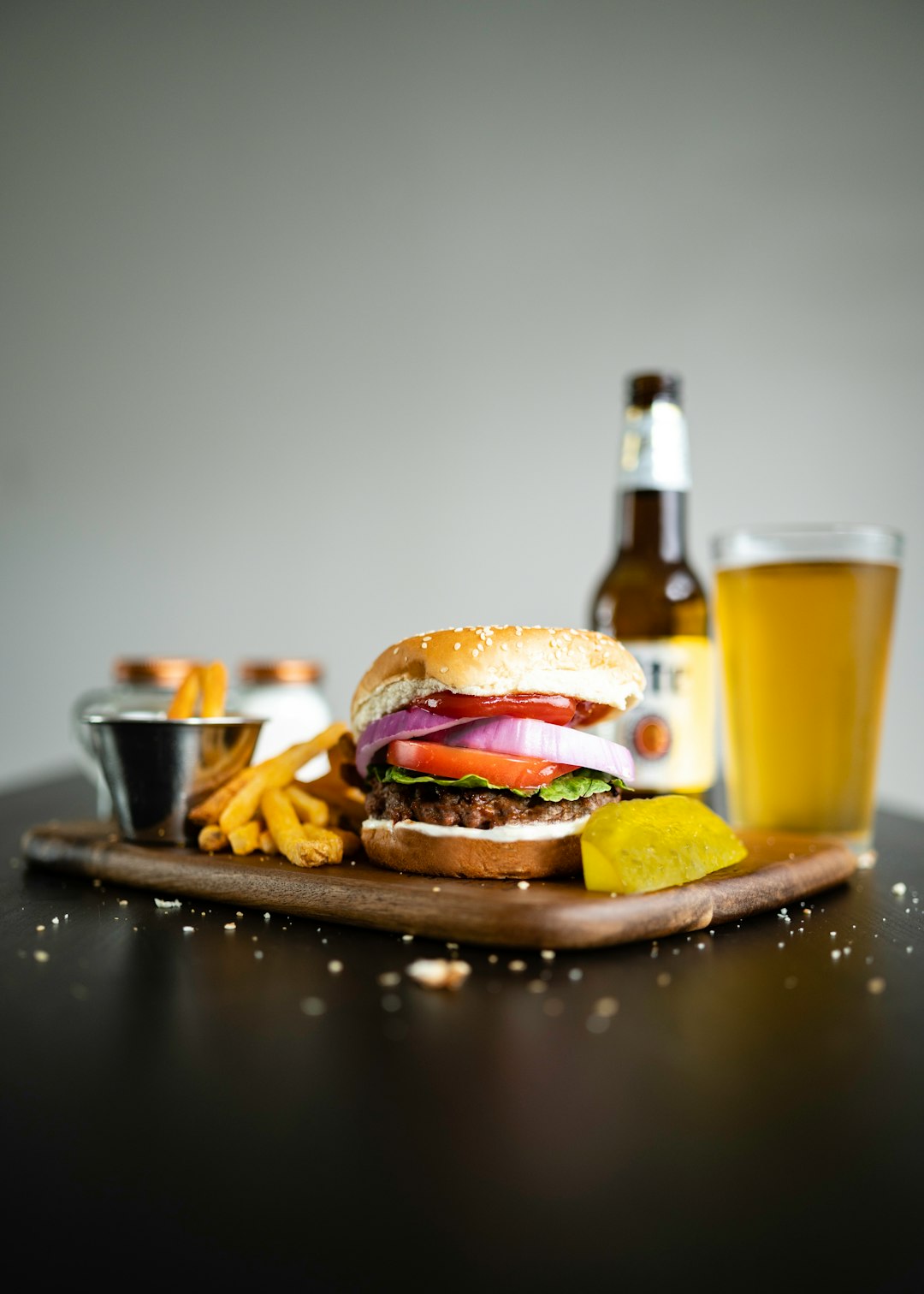 burger on black ceramic plate beside drinking glass