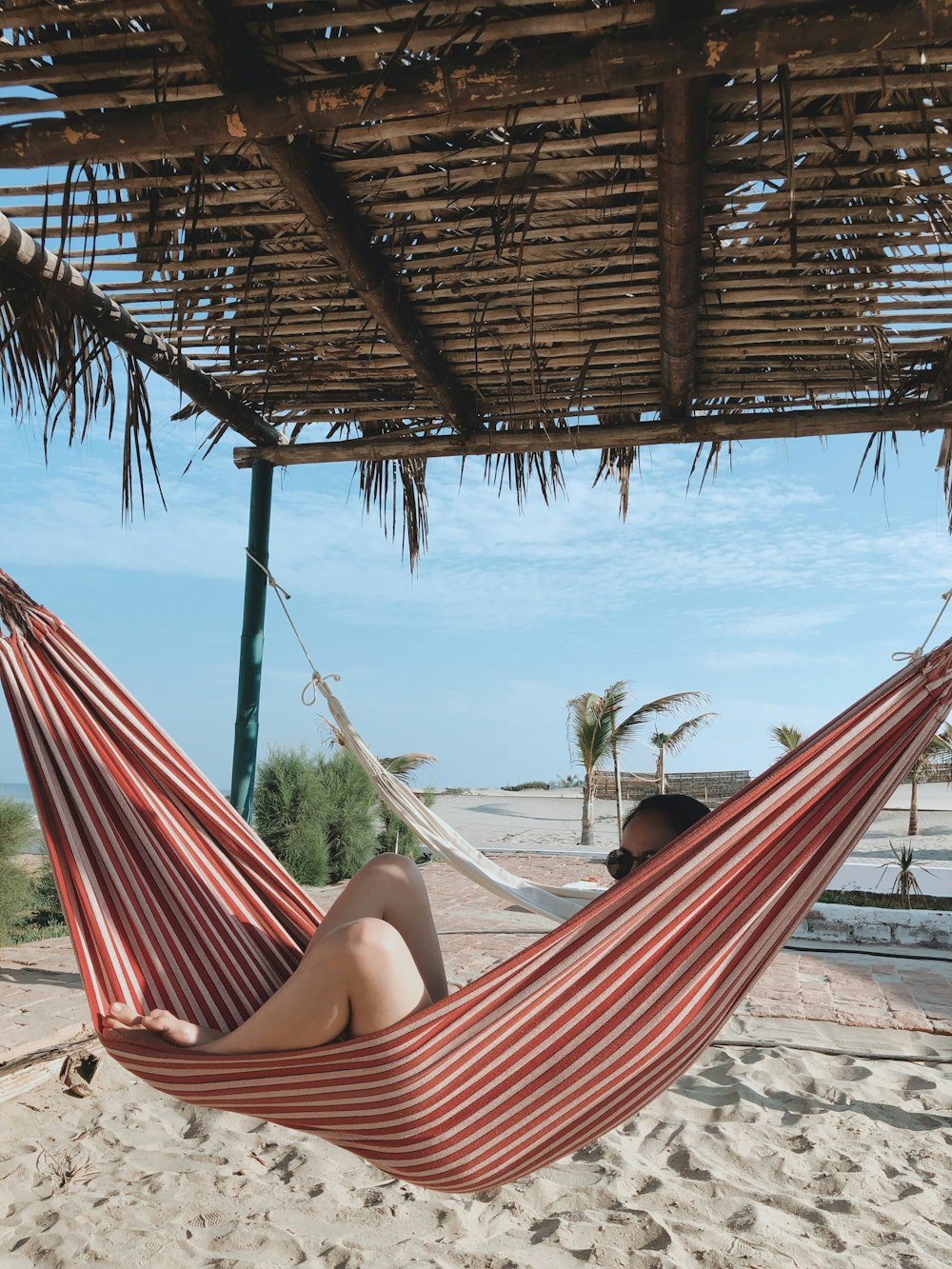 woman lying on red hammock