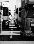 grayscale photo of cars on road