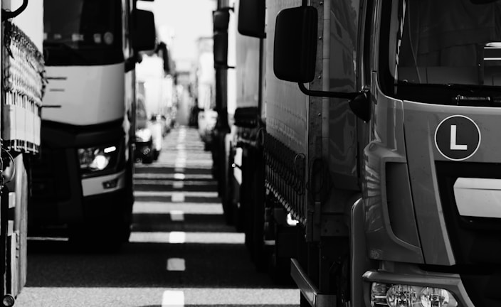 grayscale photo of cars on road