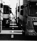 grayscale photo of cars on road