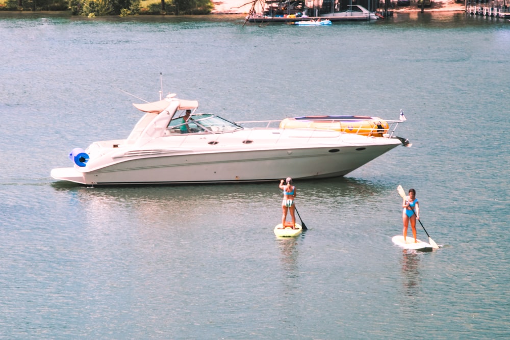 man in yellow shirt standing on white boat on sea during daytime