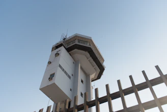 A secure government facility with modern infrastructure set against a clear sky.