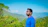 man in blue crew neck shirt wearing black framed eyeglasses standing near green plants during daytime