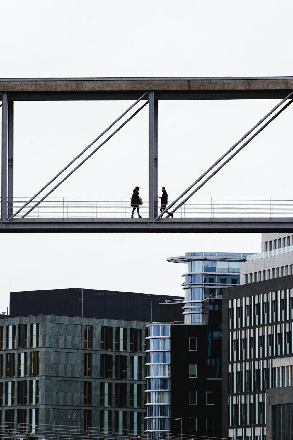 man in black jacket and pants standing on black metal frame during daytime