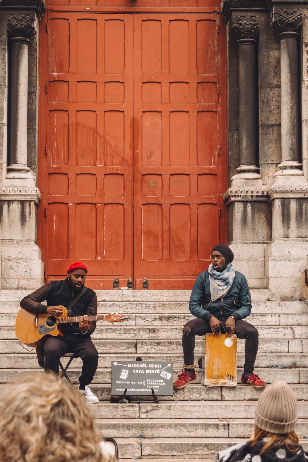 man in blue jacket playing guitar