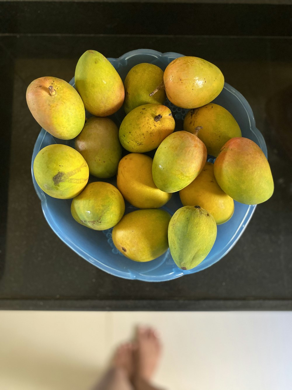 yellow citrus fruits on blue ceramic bowl