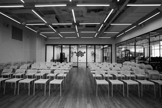 grayscale photo of empty chairs