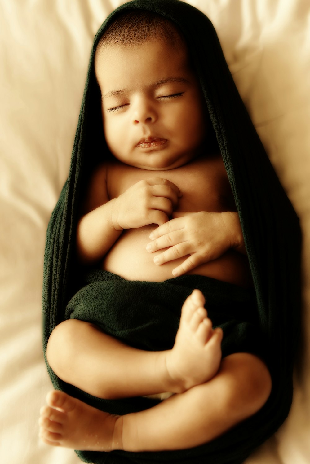 topless baby lying on bed