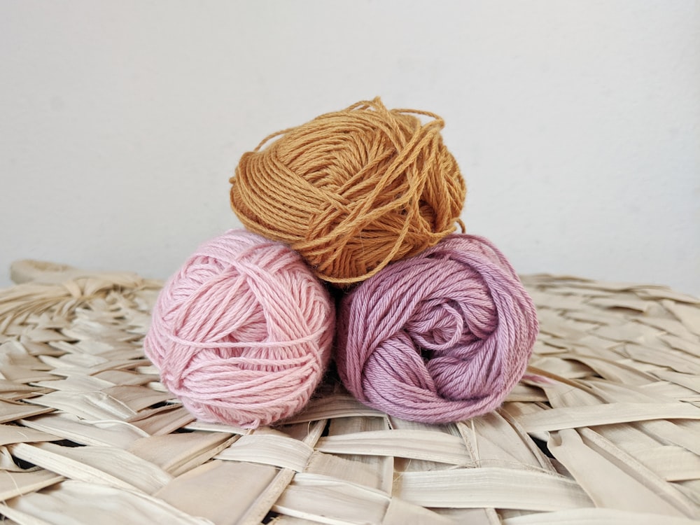 orange yarn on brown woven basket