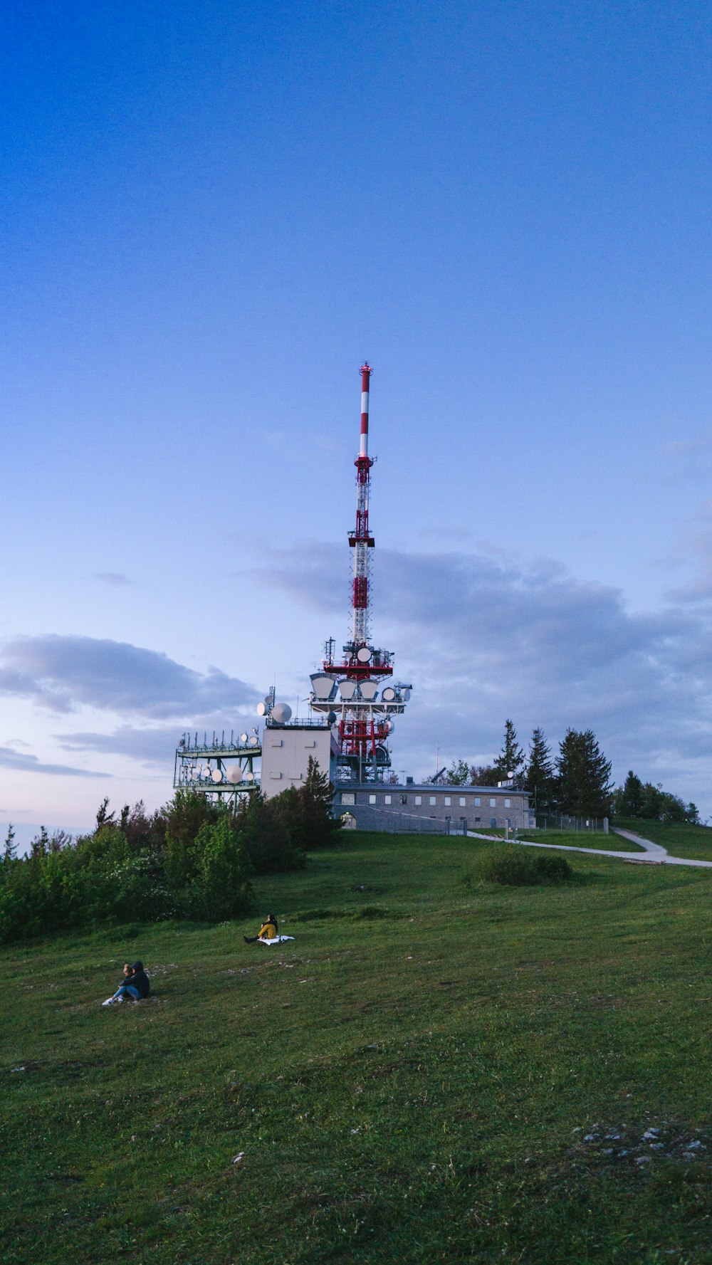 white and red tower on green grass field