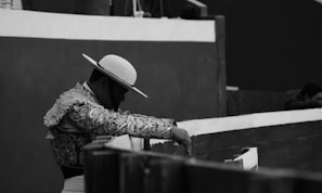 An evocative black and white portrait of a torero preparing backstage.