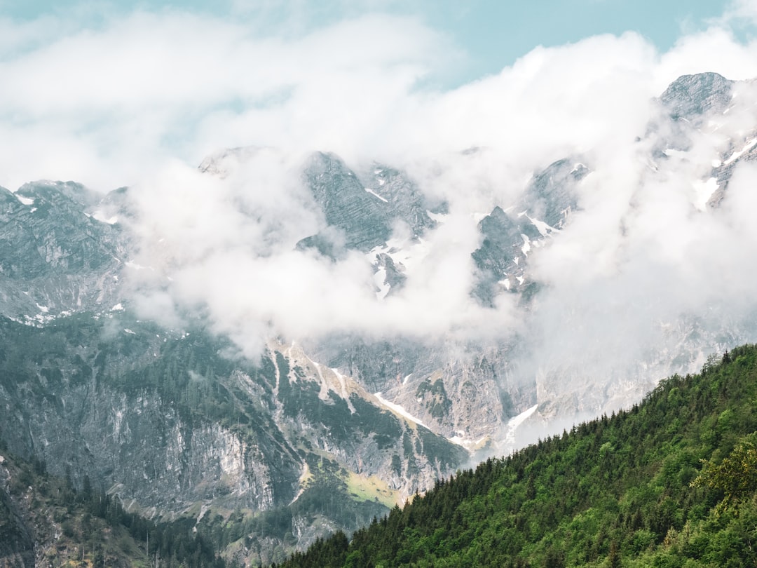 green and white mountain under white clouds during daytime