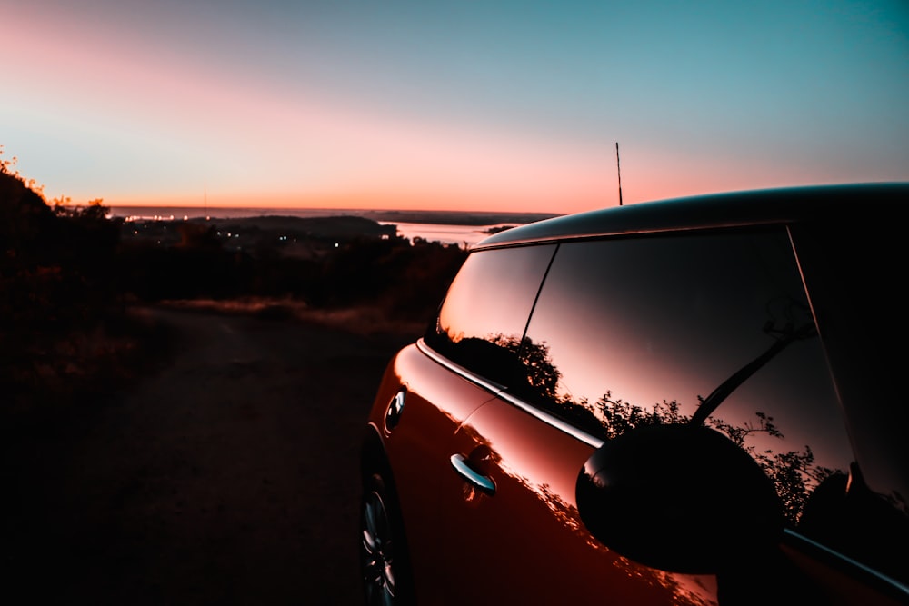 black car on road during sunset