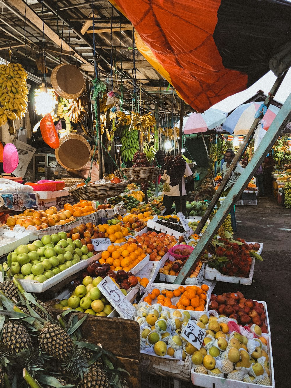 orange and green fruits on fruit stand