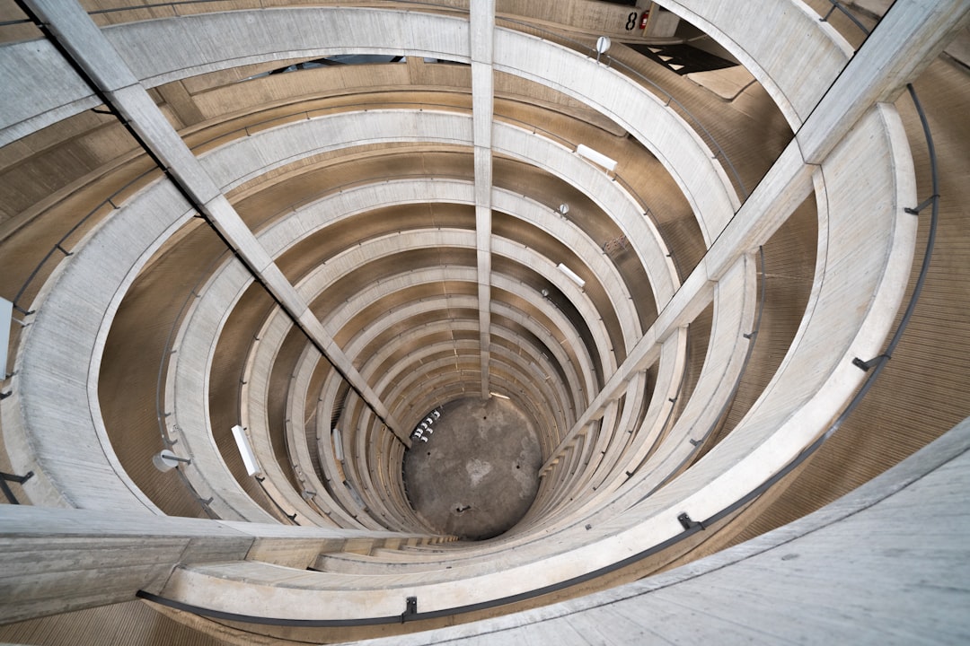 brown wooden spiral staircase with round black ceiling lamp