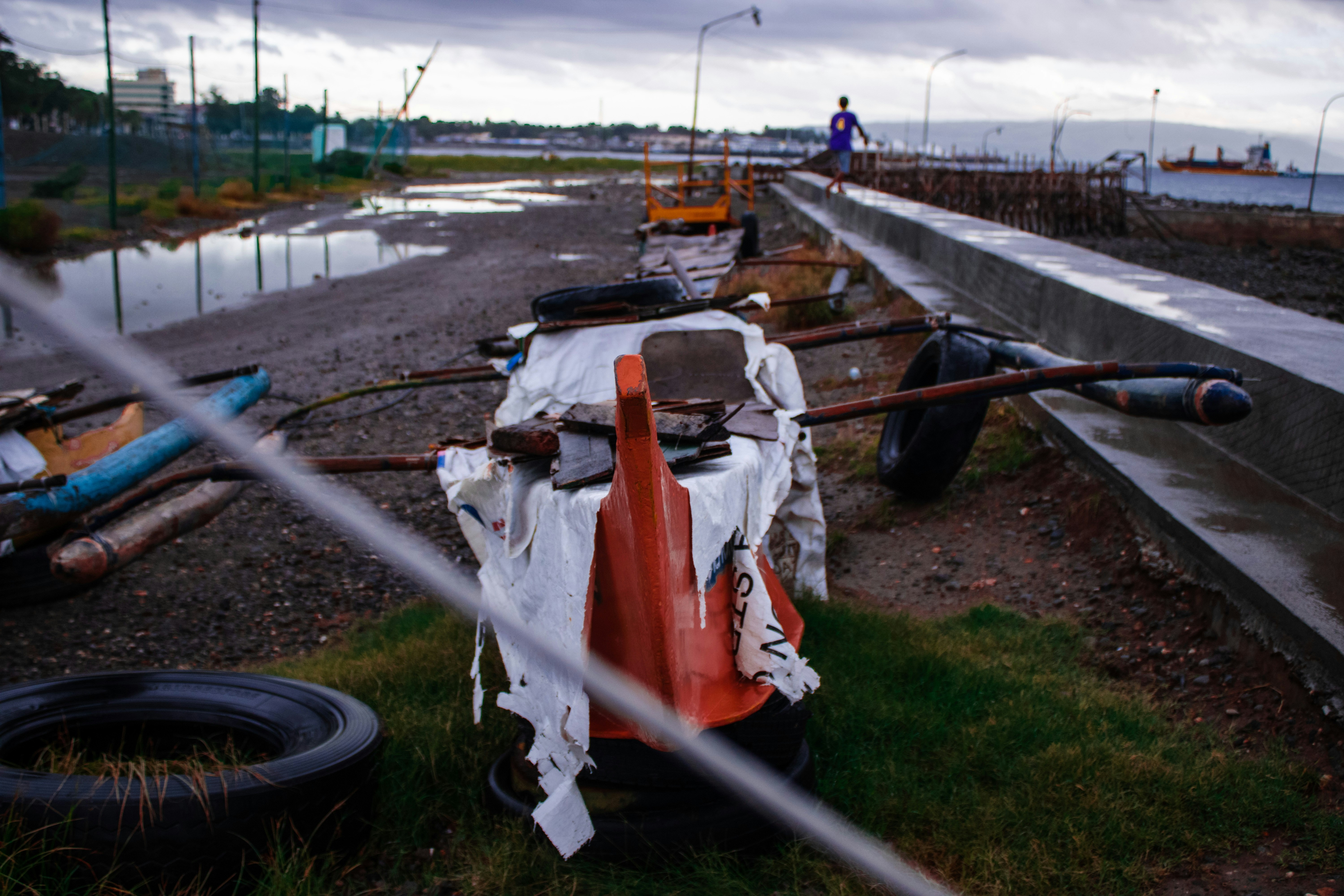 white and orange plastic bags on gray metal fence
