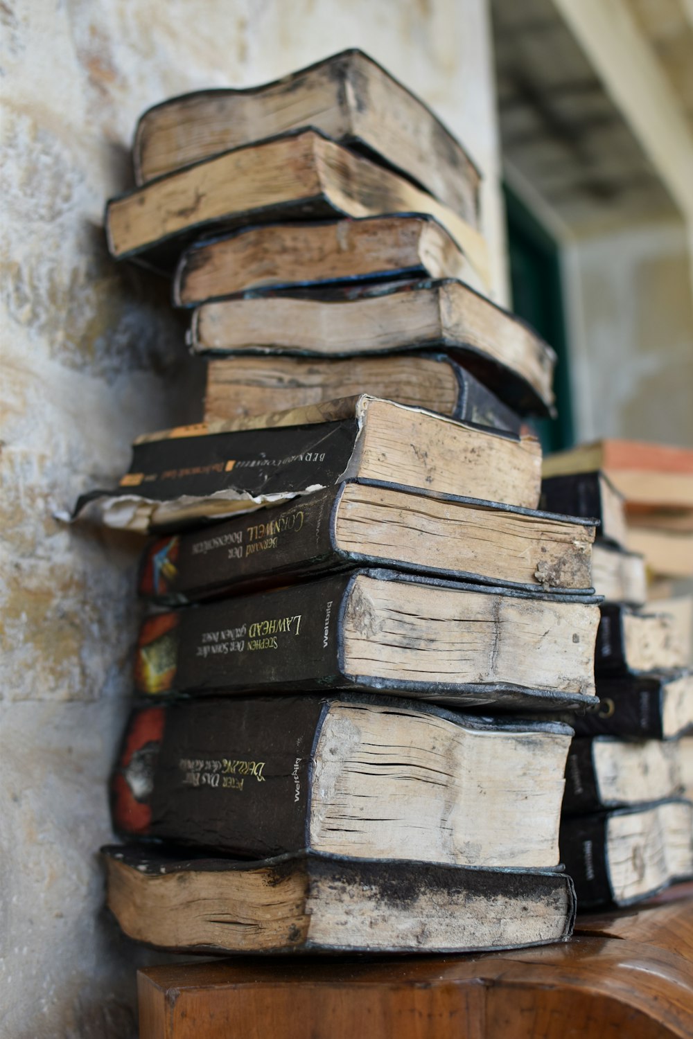 stack of books on white concrete wall