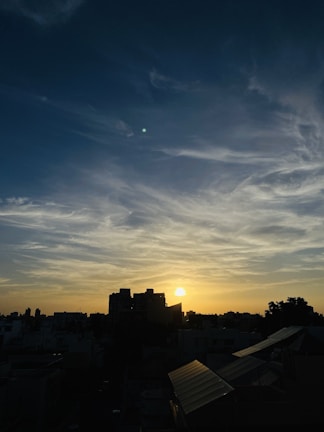 A serene urban sunset captured with soft golden light highlighting the cityscape.