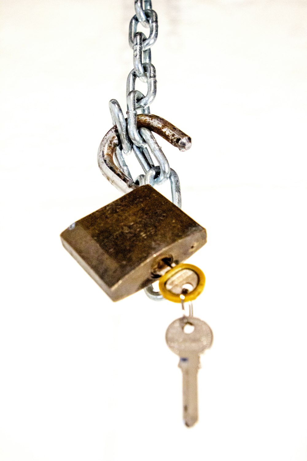 brass padlock with key on white background