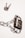 A padlock securely fastened with a chain, placed next to a set of keys on a white background. The metal surface of the padlock and chain reflects light, giving a shiny appearance.