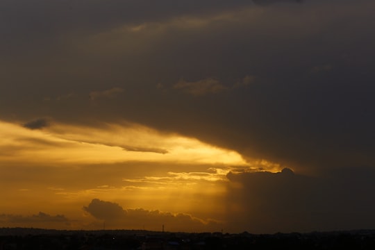 silhouette of trees under cloudy sky during sunset in Accra Ghana