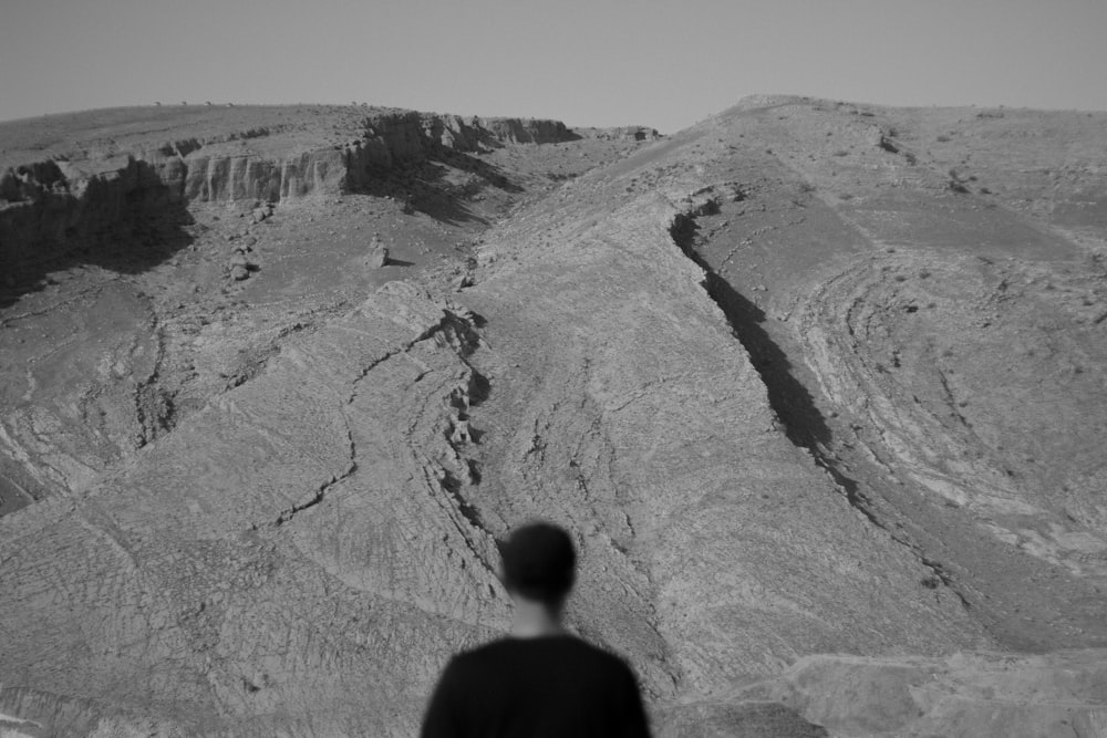 man in black shirt standing on hill