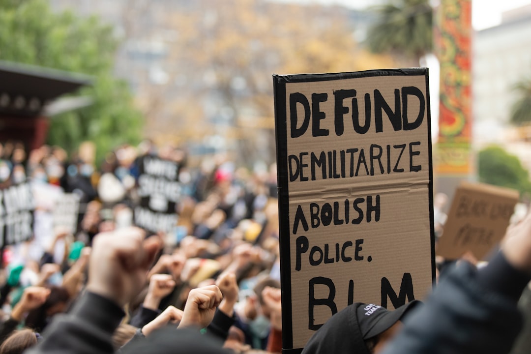 people holding brown wooden signage during daytime