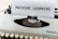 A vintage typewriter with a sheet of paper on which the words 'MACHINE LEARNING' are typed in bold. The typewriter appears to be an older model with black keys and a white body, placed on a wooden surface.