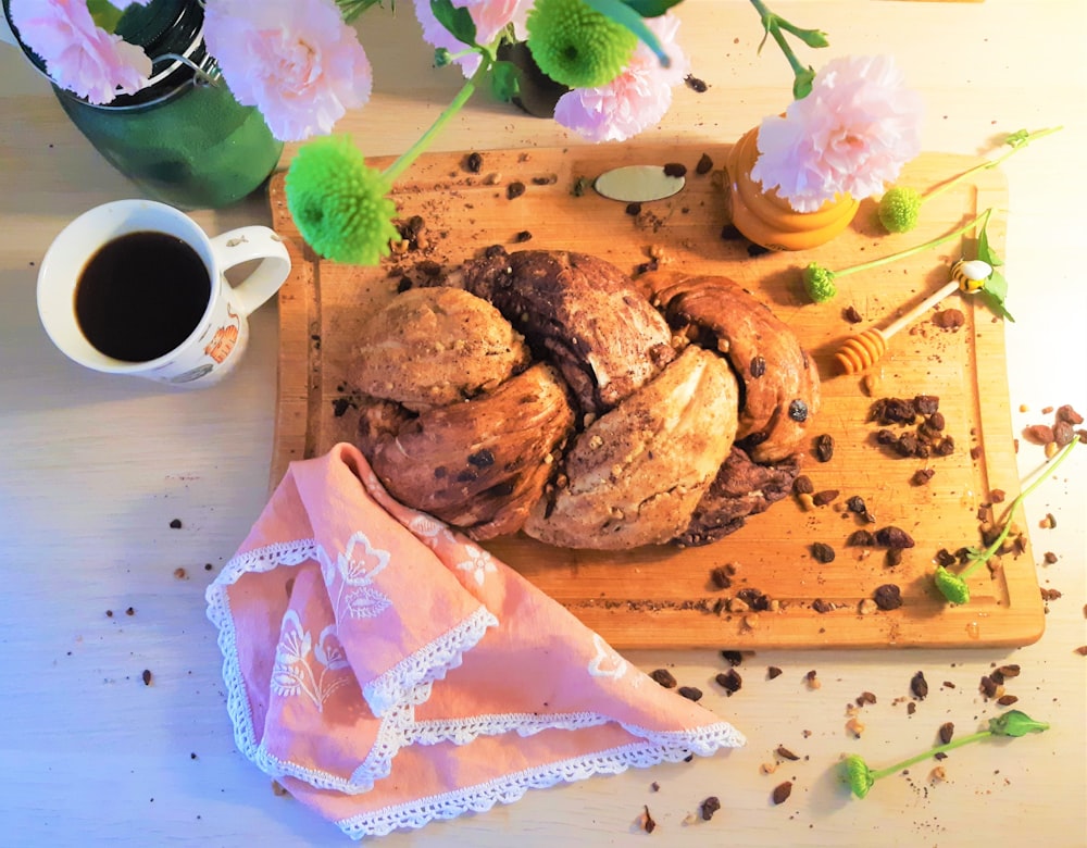 brown bread with pink flower on white ceramic plate