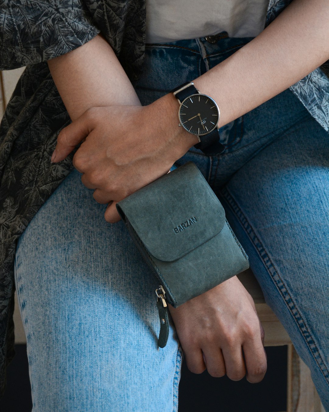 person holding blue leather wallet