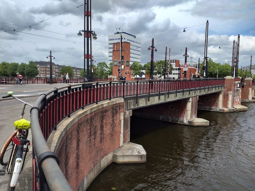 brown concrete bridge over river during daytime