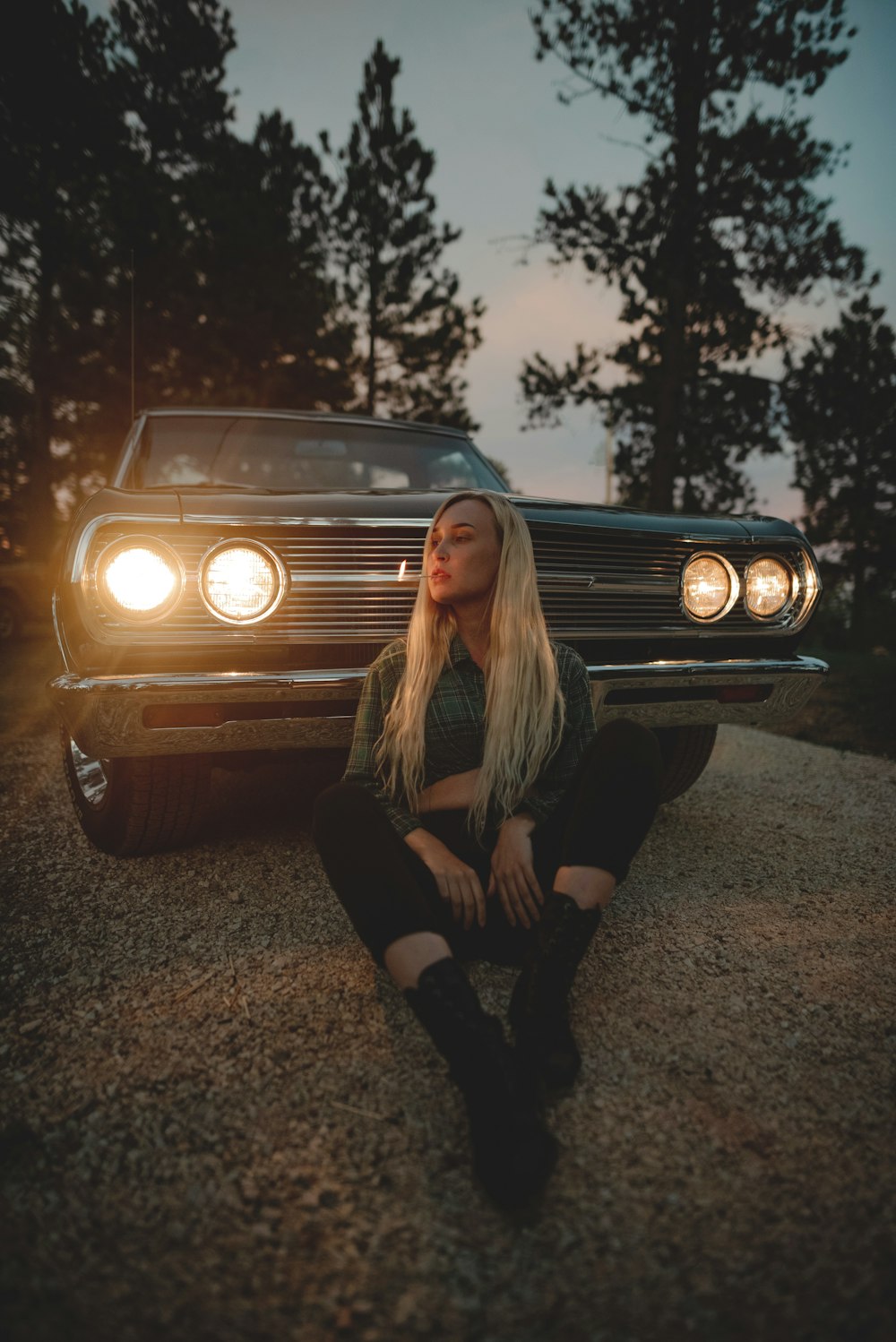 woman in black long sleeve shirt leaning on brown car