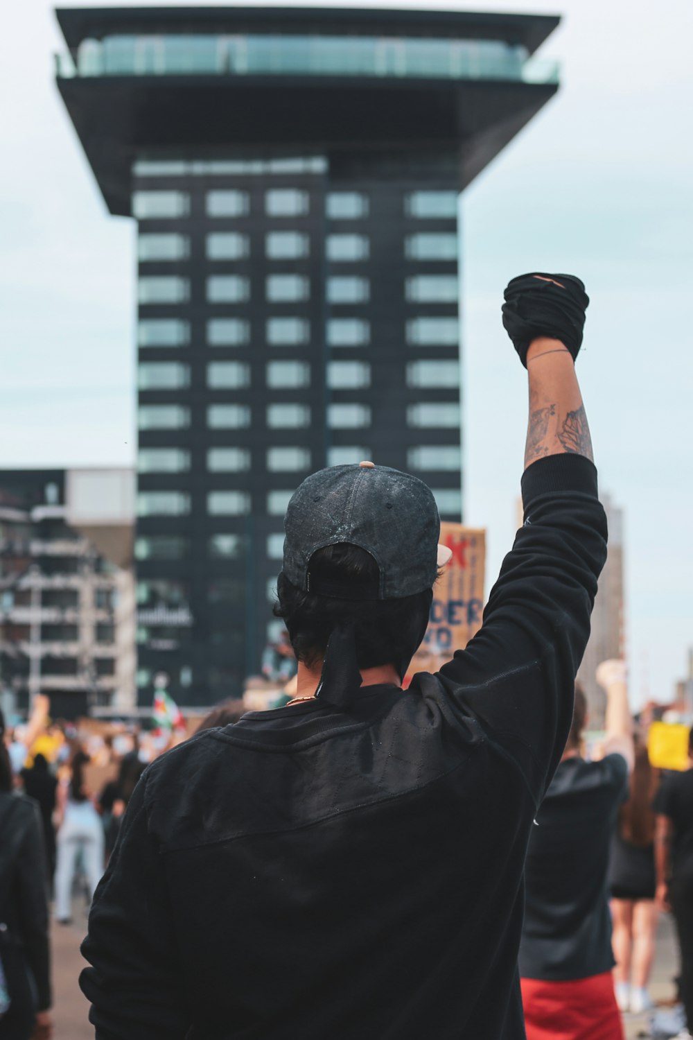 man in black jacket holding black dslr camera