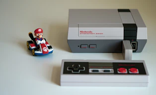 A classic NES console with controller on a wooden table