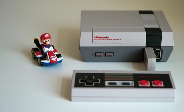 A classic NES console with controller on a wooden table