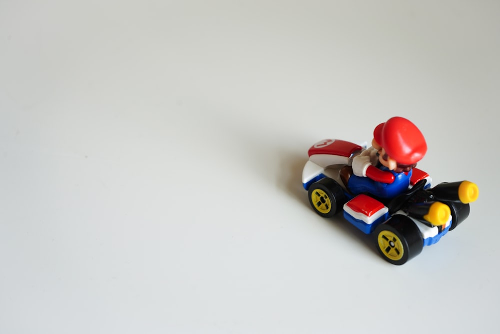 red yellow and blue plastic toy car