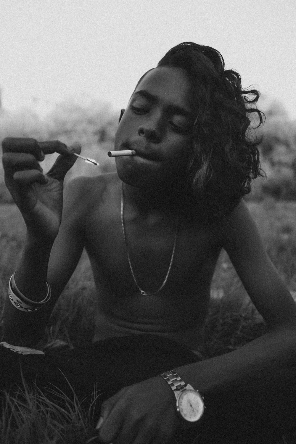 grayscale photo of woman smoking cigarette