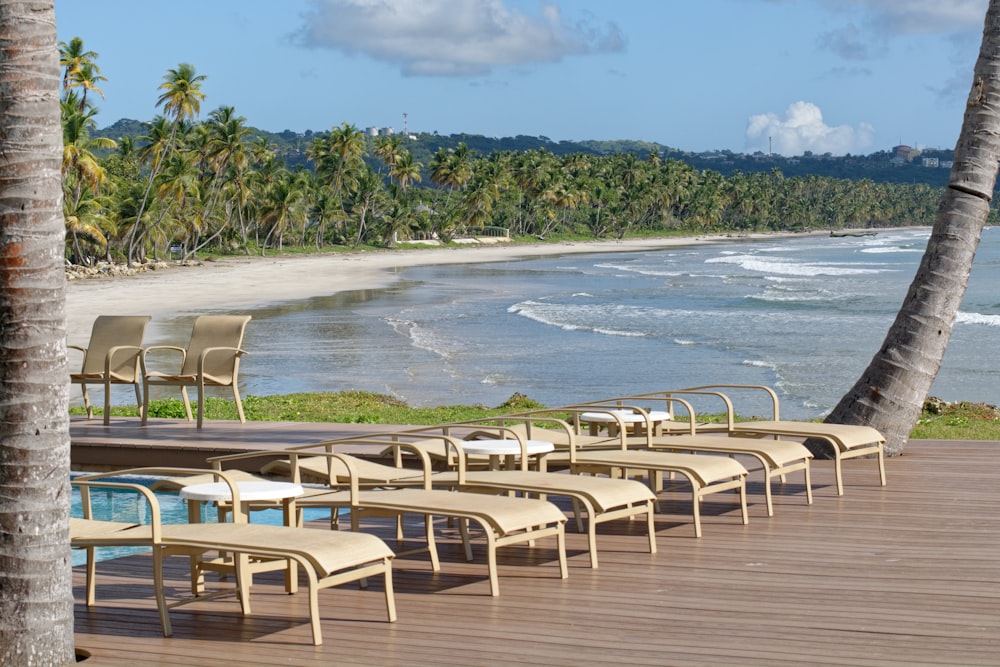 white and gray chairs on seashore during daytime